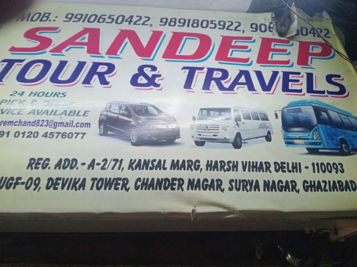 The Sandeep Tour & Travels hoarding with the fleet painted on it